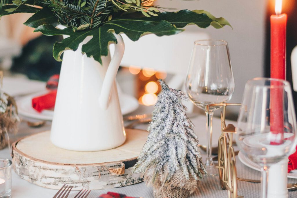 Christmas dinner table with red candles and white plates